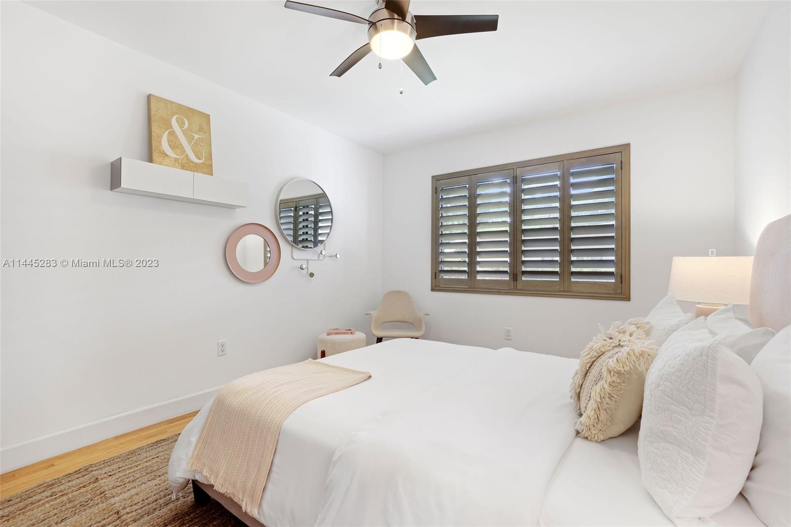 3411 Riviera Drive Coral Gables, FL 33134 - Photo 26 of 38 a bedroom with a bed and a window