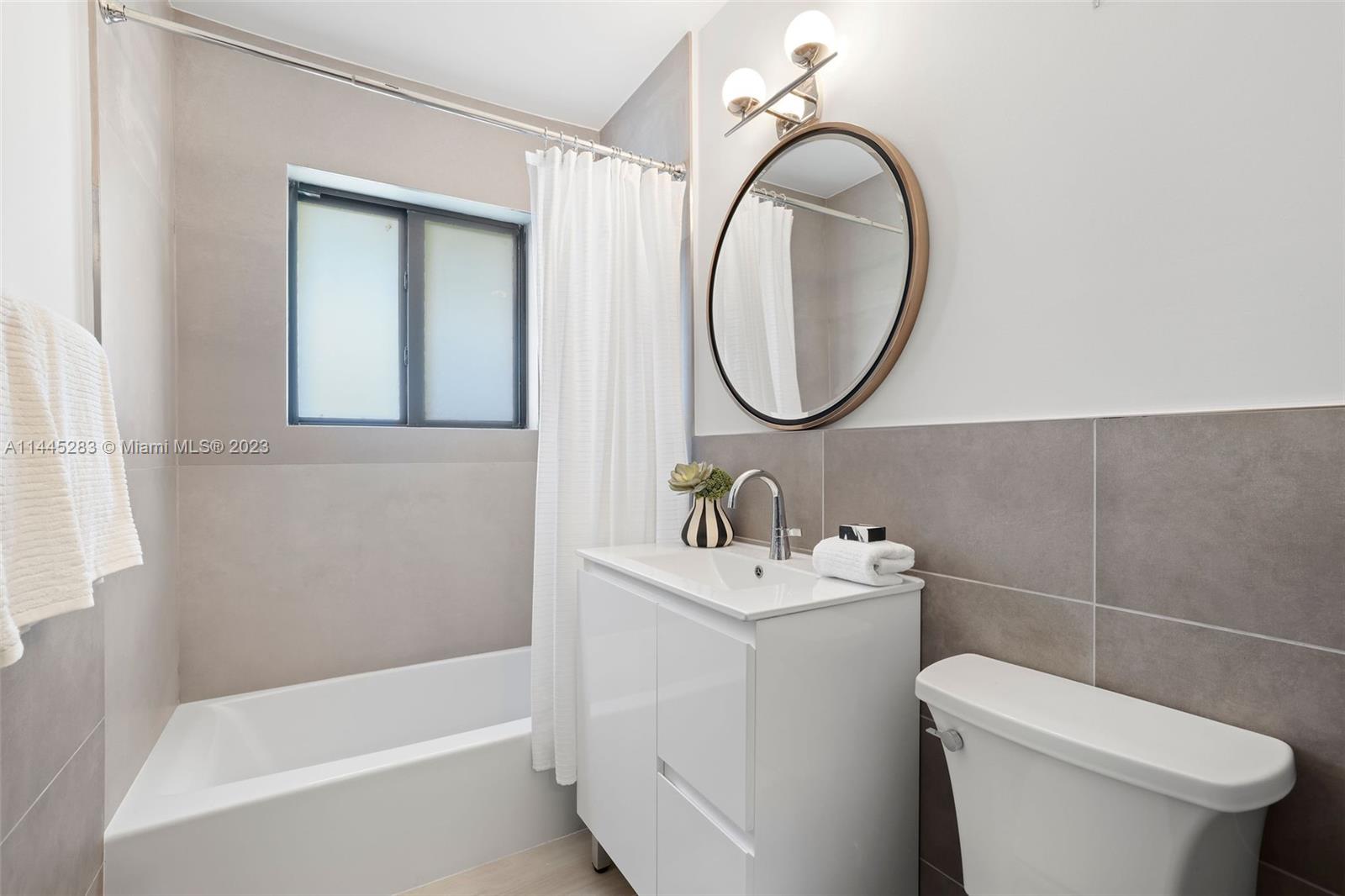 3411 Riviera Drive Coral Gables, FL 33134 - Photo 27 of 38 a bathroom with a sink a toilet and a mirror