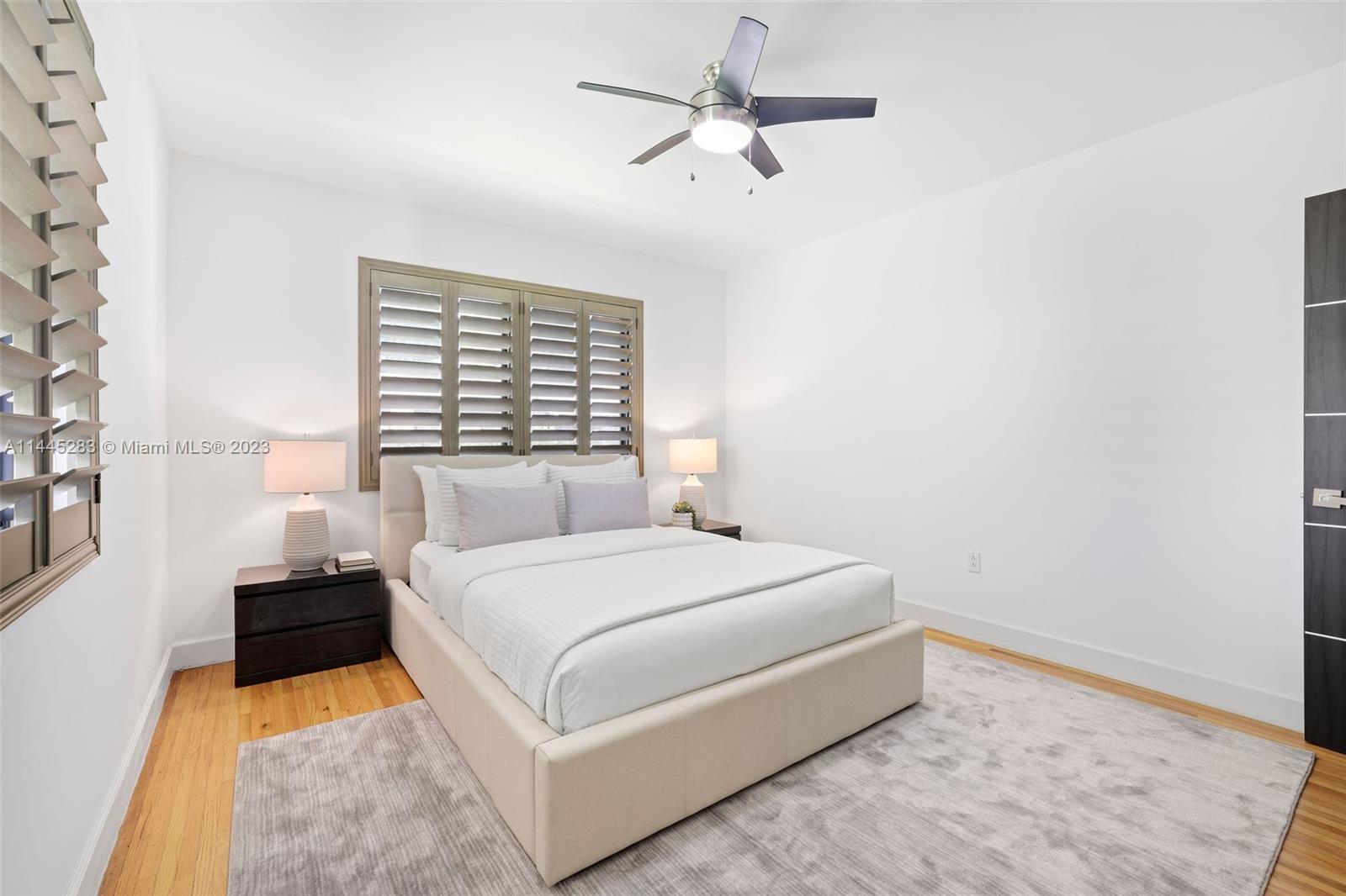 3411 Riviera Drive Coral Gables, FL 33134 - Photo 29 of 38 a bedroom with a bed and a chandelier