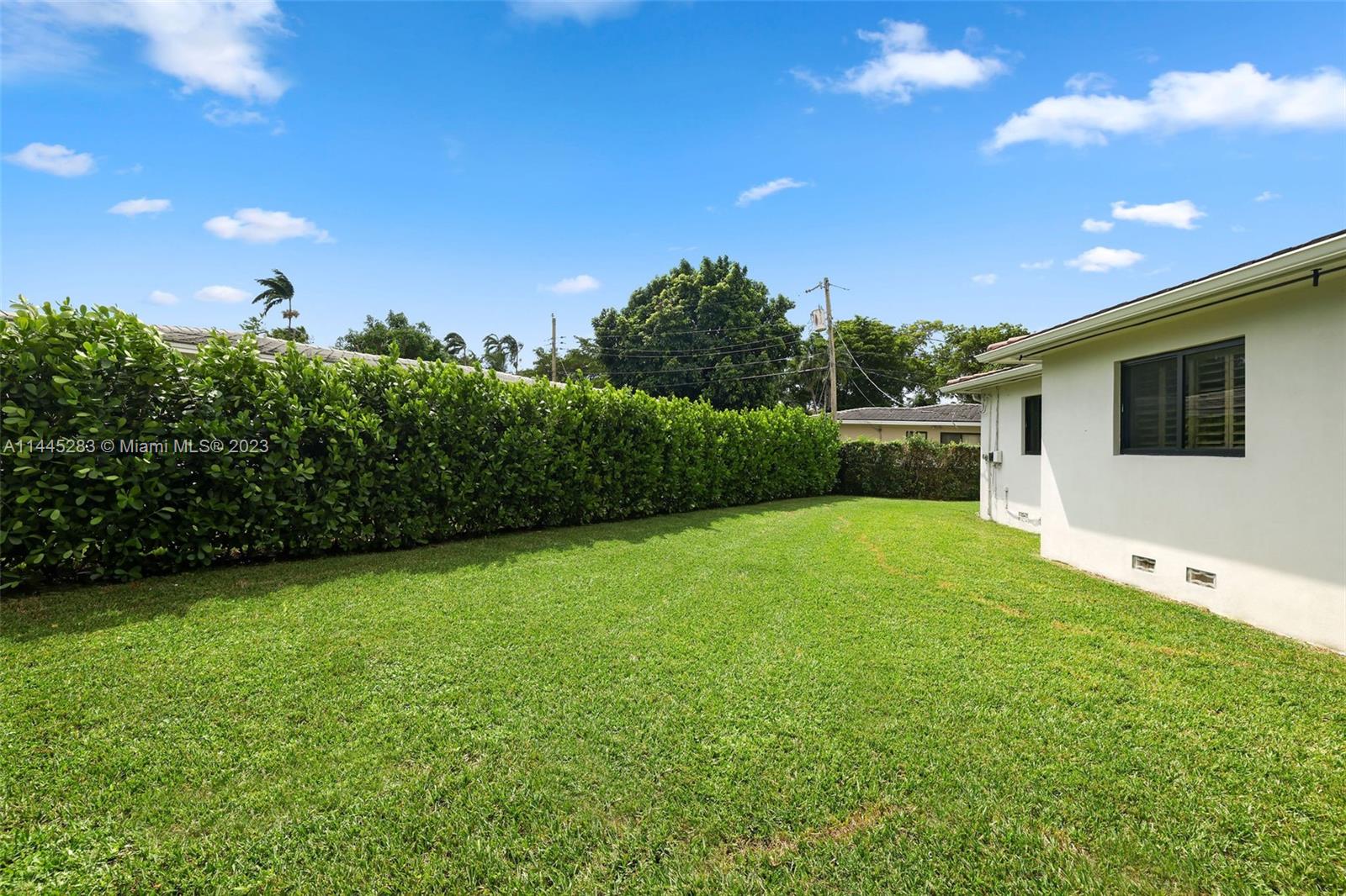 3411 Riviera Drive Coral Gables, FL 33134 - Photo 32 of 38 a view of a backyard with plants and a garden