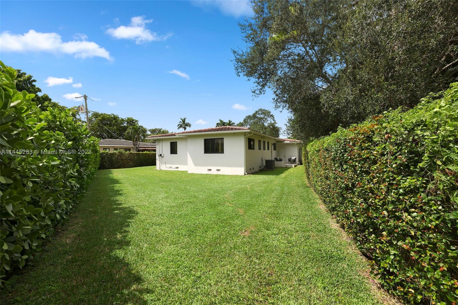 3411 Riviera Drive Coral Gables, FL 33134 - Photo 33 of 38 a view of a backyard with plants and a garden
