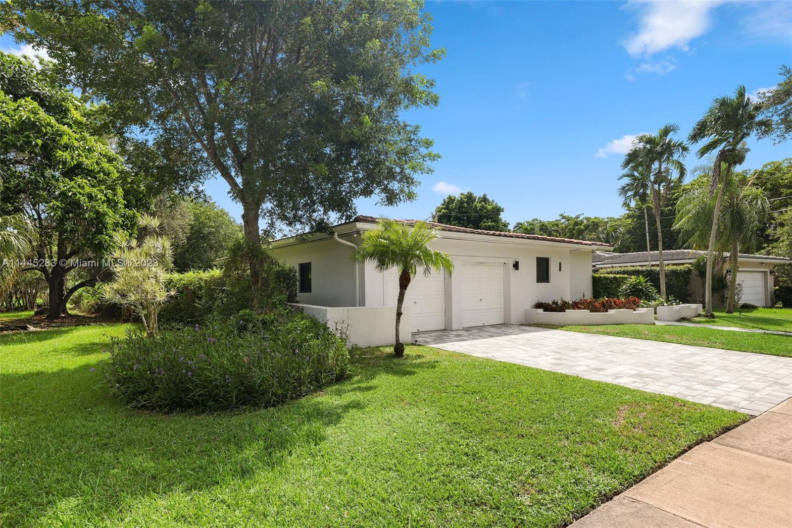 3411 Riviera Drive Coral Gables, FL 33134 - Photo 37 of 38 a house view with a sitting space and garden