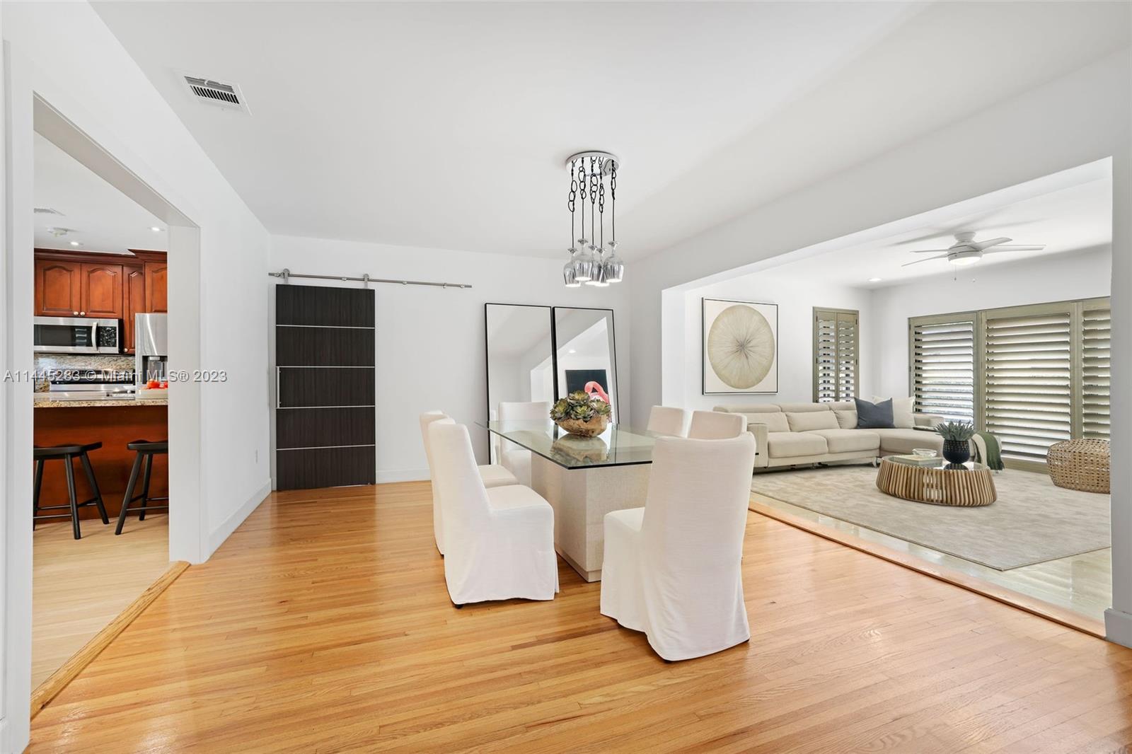 3411 Riviera Drive Coral Gables, FL 33134 - Photo 6 of 38 a living room with fireplace furniture and a wooden floor