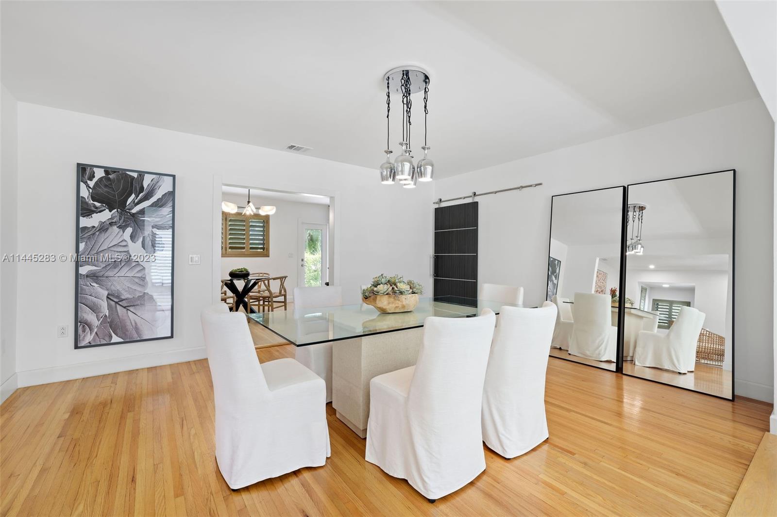 3411 Riviera Drive Coral Gables, FL 33134 - Photo 7 of 38 a view of a dining room with furniture and wooden floor