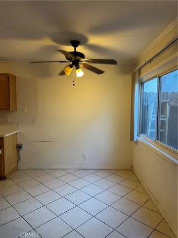 a view of a room with a window and a fan