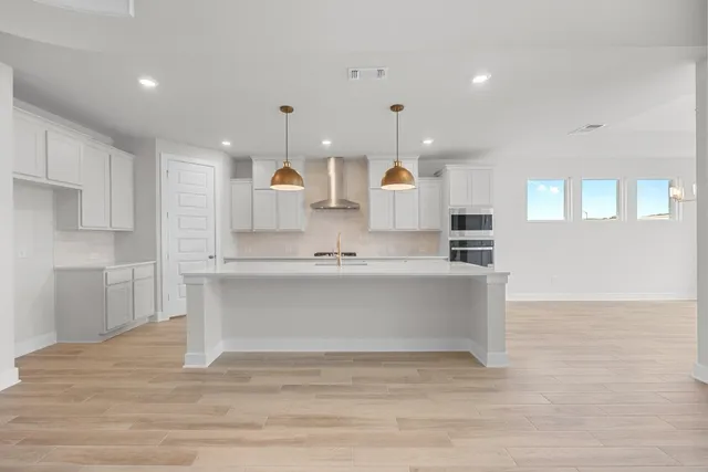a view of kitchen with wooden floor and electronic appliances