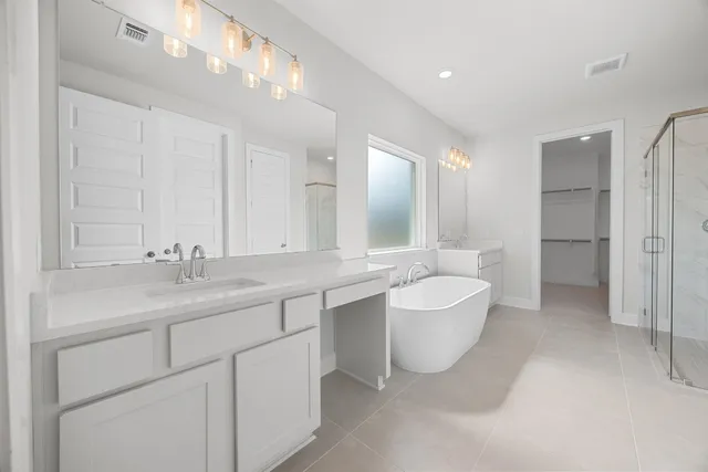 a bathroom with a double vanity sink mirror and bathtub