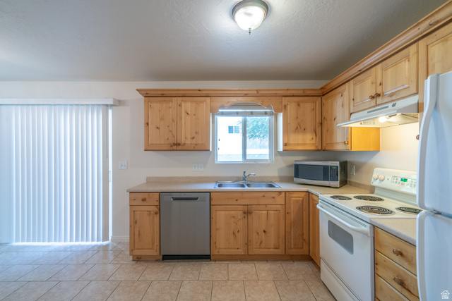 1735 West 540 North, Unit 1805 St. George, UT 84770 - Photo 25 of 64 Kitchen featuring light wood cabinetry, laminate countertops, a stainless steel dishwasher, and a white electric range