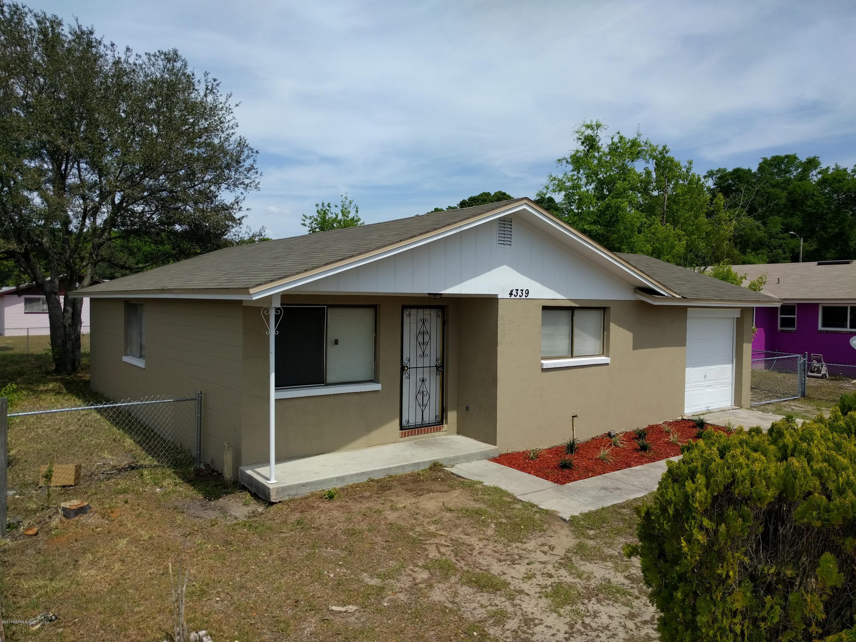 4339 Flintshire Road Jacksonville, FL 32208 - Photo 3 of 15 a front view of a house with a yard and garage