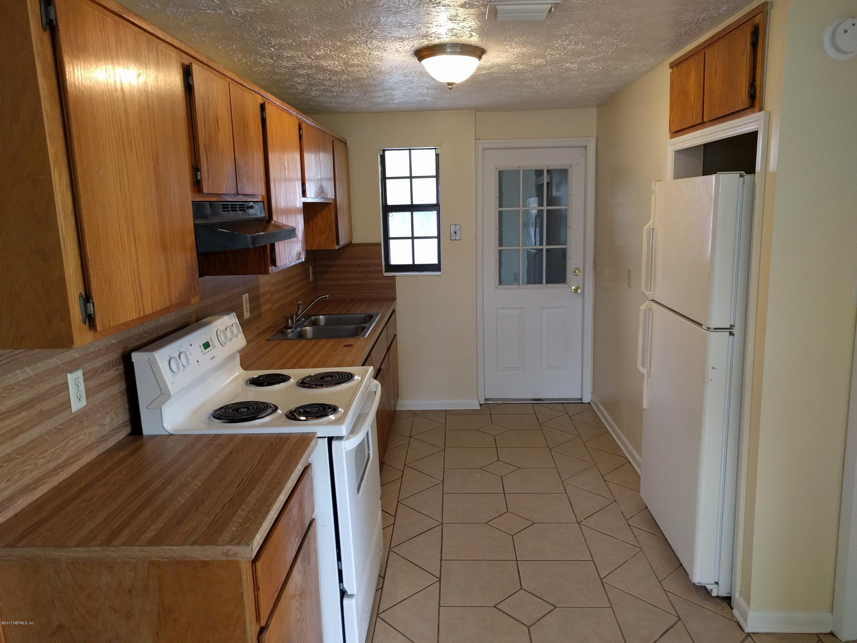 4339 Flintshire Road Jacksonville, FL 32208 - Photo 8 of 15 a kitchen with a stove and a refrigerator