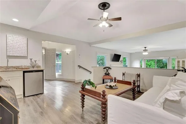 a living room with furniture and kitchen view