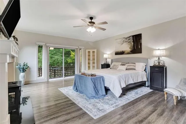 a bedroom with a large bed and a chandelier