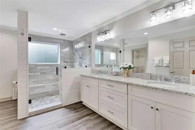 a bathroom with a granite countertop sink mirror and shower