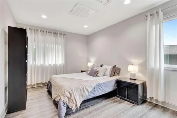 a bedroom with a bed and a window