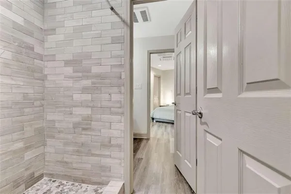 a bathroom with a glass shower door