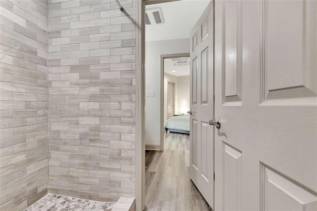 4 Northlake Circle Peachtree City, GA 30269 - Photo 24 of 33 a bathroom with a glass shower door