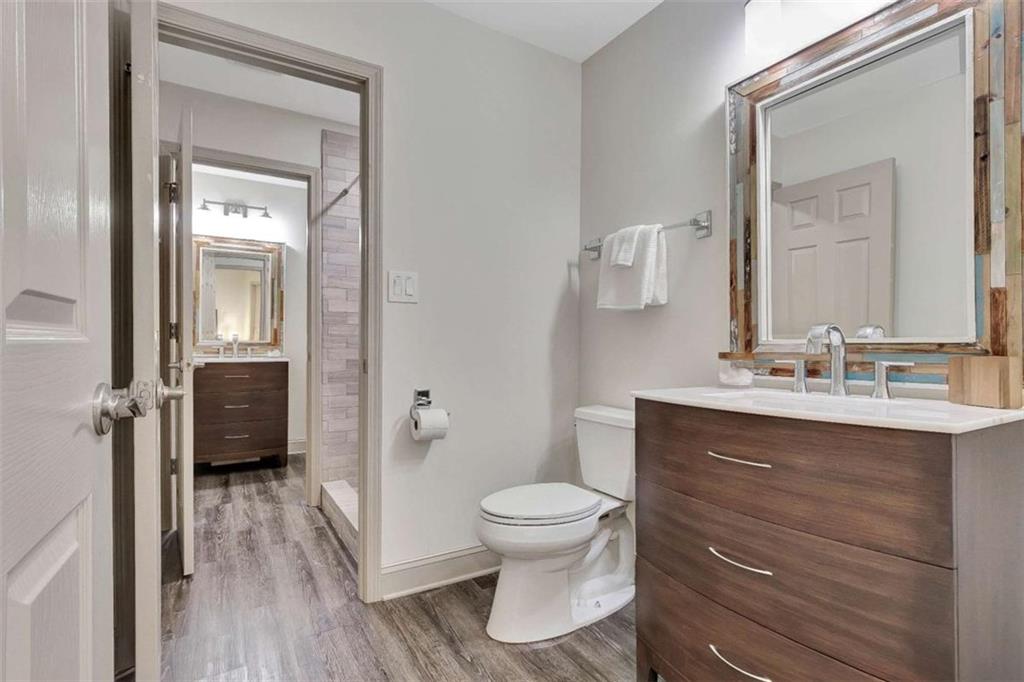 4 Northlake Circle Peachtree City, GA 30269 - Photo 25 of 33 a bathroom with a toilet a sink a mirror and shower