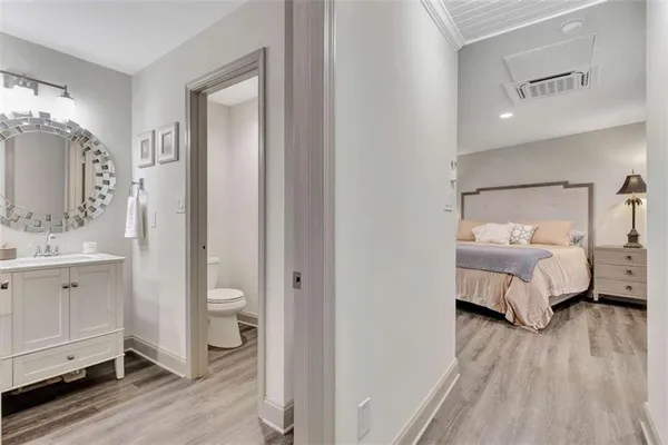 a bedroom with a bed and wooden floor