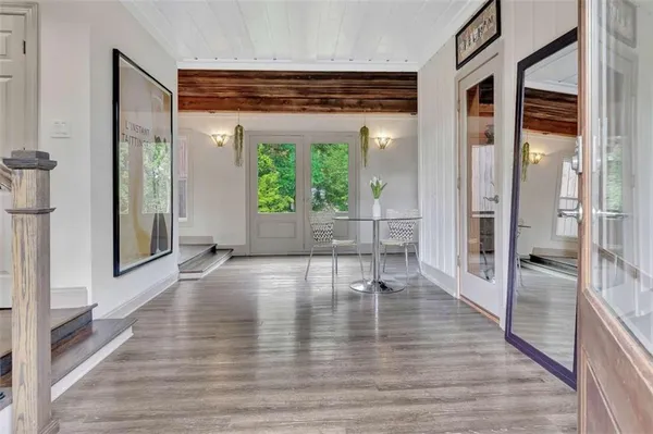 a view of empty room with wooden floor and windows