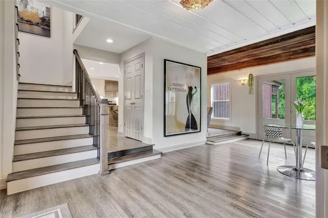 a view of an entryway with wooden floor and door