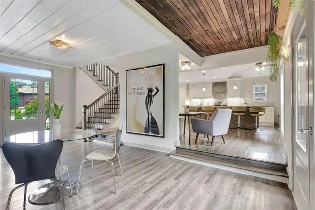 a dining room with furniture and wooden floor