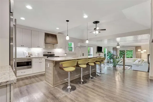 a large kitchen with a table and chairs