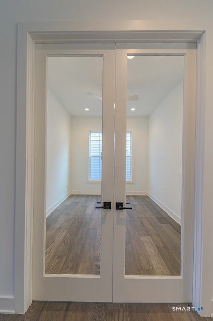 35 Lookout Ridge, Unit 35 Danbury, CT 06810 - Photo 11 of 38 an empty room with wooden floor and windows