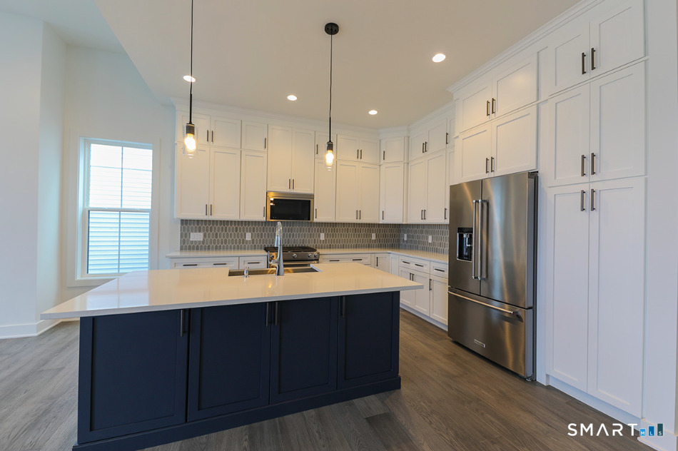 35 Lookout Ridge, Unit 35 Danbury, CT 06810 - Photo 14 of 38 a kitchen with kitchen island stainless steel appliances a sink stove and refrigerator