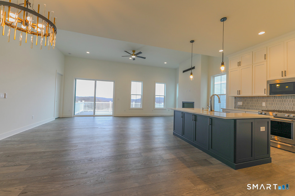35 Lookout Ridge, Unit 35 Danbury, CT 06810 - Photo 15 of 38 a large kitchen with granite countertop a large counter top a sink stainless steel appliances and cabinets