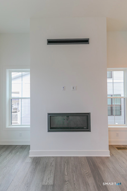 35 Lookout Ridge, Unit 35 Danbury, CT 06810 - Photo 19 of 38 a view of an empty room with wooden floor and a window