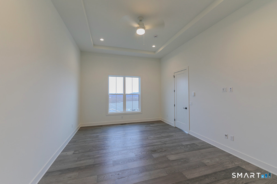 35 Lookout Ridge, Unit 35 Danbury, CT 06810 - Photo 22 of 38 wooden floor in an empty room with a window