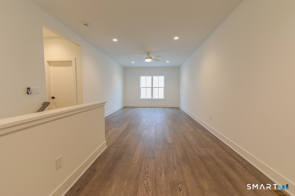 35 Lookout Ridge, Unit 35 Danbury, CT 06810 - Photo 30 of 38 a view of an empty room with wooden floor and a window