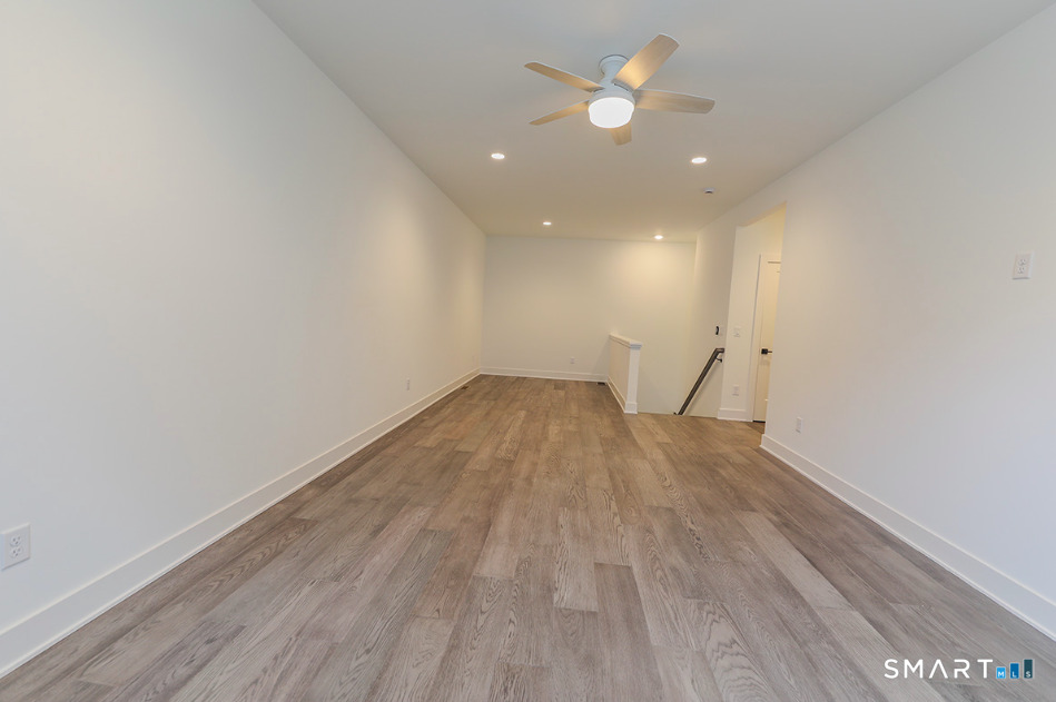 35 Lookout Ridge, Unit 35 Danbury, CT 06810 - Photo 31 of 38 a view of a room with wooden floor and a ceiling fan