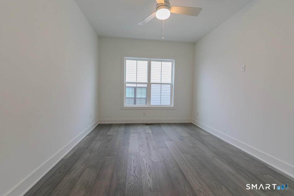 35 Lookout Ridge, Unit 35 Danbury, CT 06810 - Photo 33 of 38 an empty room with wooden floor and windows