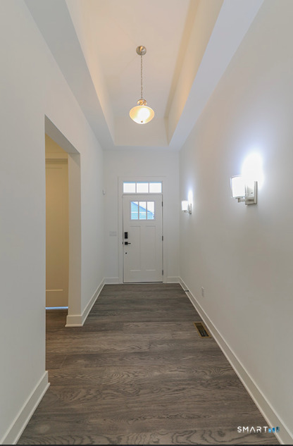 35 Lookout Ridge, Unit 35 Danbury, CT 06810 - Photo 4 of 38 an empty room with wooden floor and windows