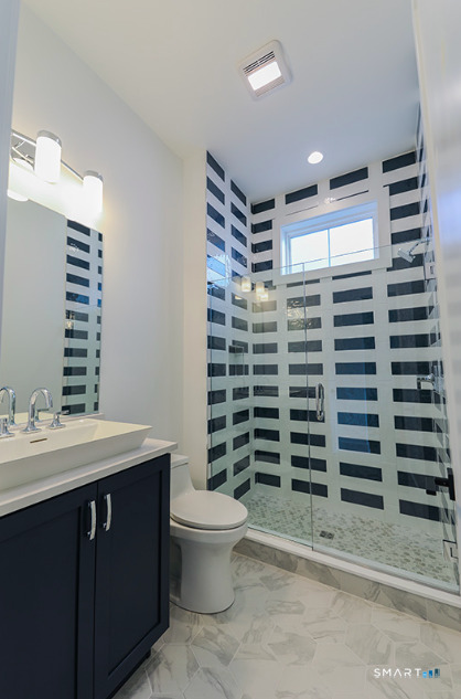 35 Lookout Ridge, Unit 35 Danbury, CT 06810 - Photo 9 of 38 a bathroom with a sink toilet and shower