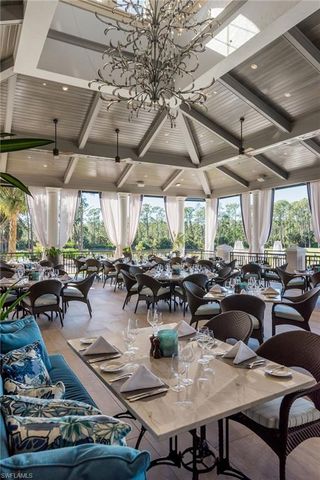 a view of a patio with couches table and chairs and potted plants