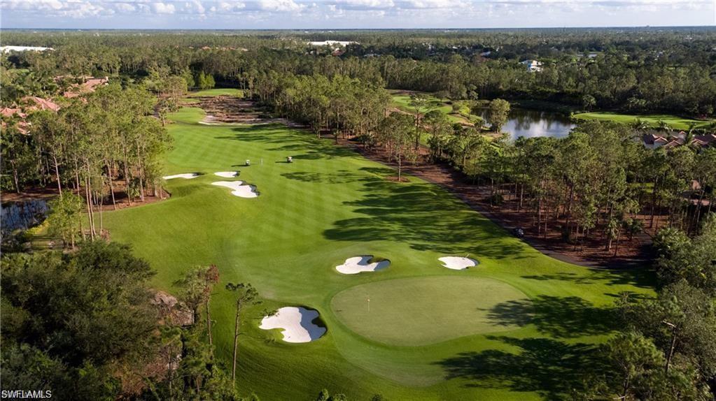 16741 Cabreo Drive Naples, FL 34110 - Photo 15 of 22 a view of a lake with a yard