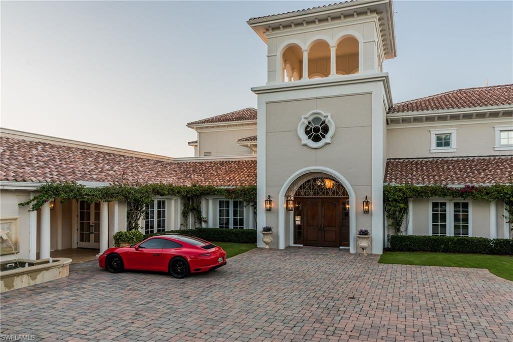 16741 Cabreo Drive Naples, FL 34110 - Photo 7 of 22 a front view of a house with a garden