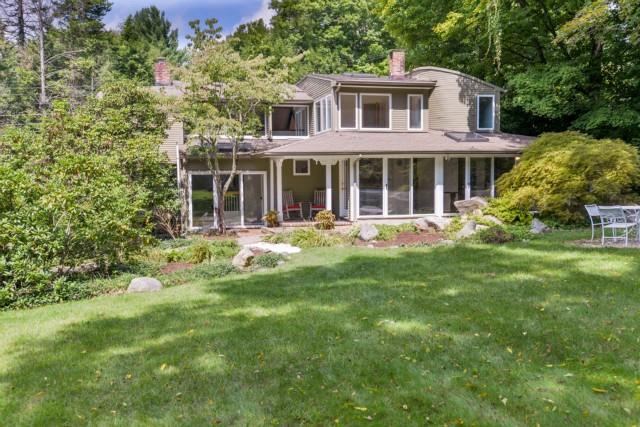 27 Grumman Hill Road Wilton, CT 06897 - Photo 1 of 1 a front view of a house with a yard table and chairs
