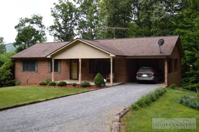 a front view of a house with a garden and yard