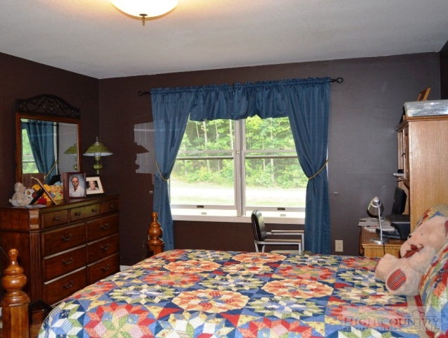 277 Pioneer Ridge Sparta, NC 28675 - Photo 4 of 36 a bedroom with a bed and a dresser
