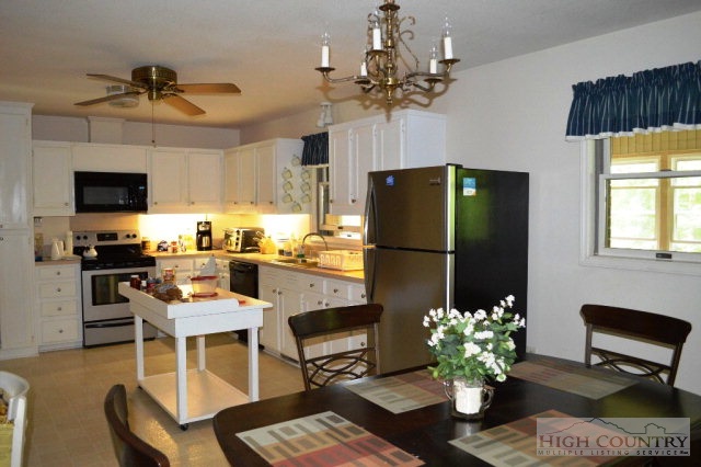 277 Pioneer Ridge Sparta, NC 28675 - Photo 10 of 36 a kitchen with stainless steel appliances granite countertop a dining table and chairs