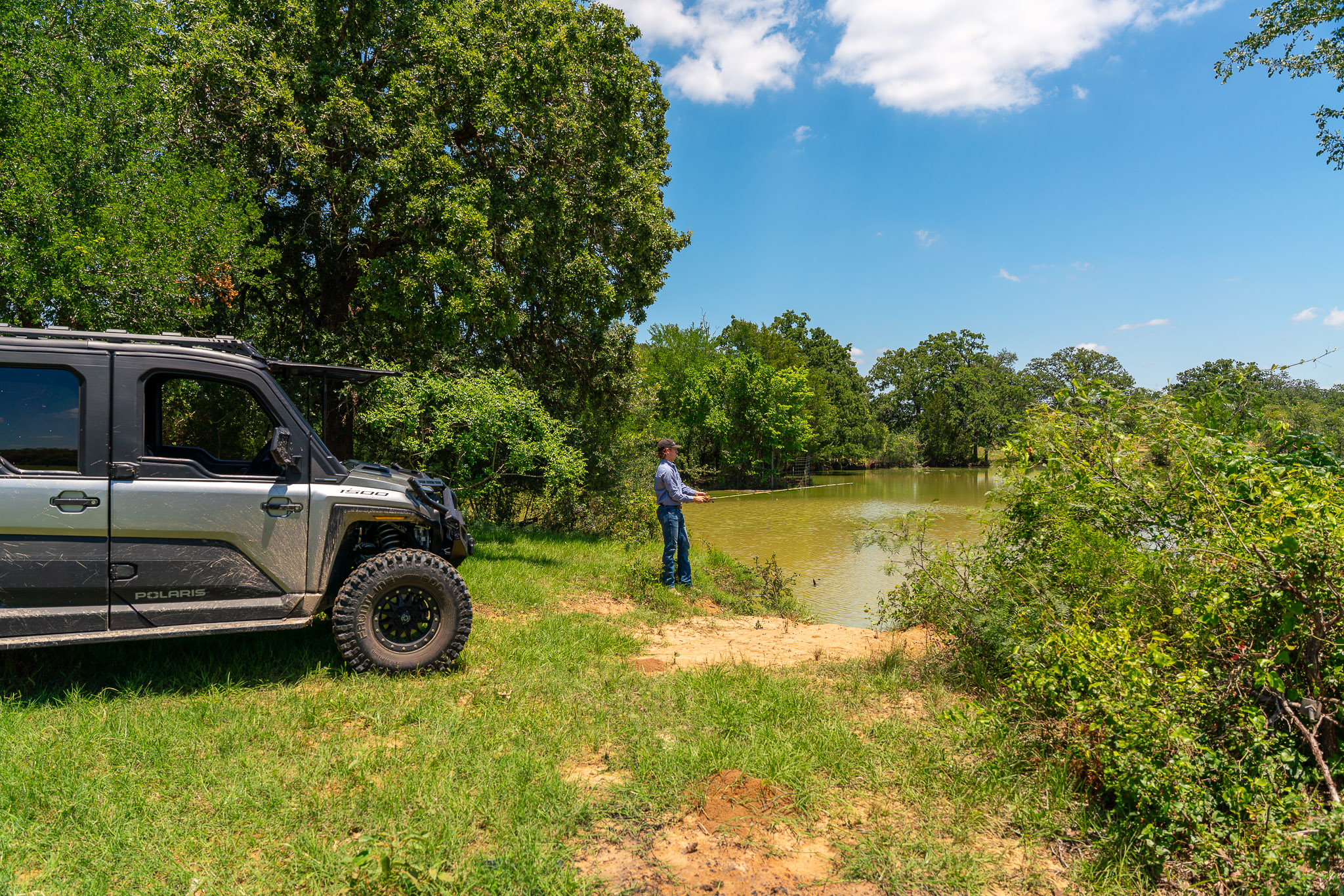 400 619th Spur Elgin, TX 78621 - Photo 18 of 40 A tranquil pond offers a private fishing retreat amid lush natural surroundings.