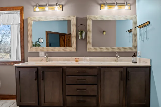 a dining room with furniture a chandelier and wooden floor