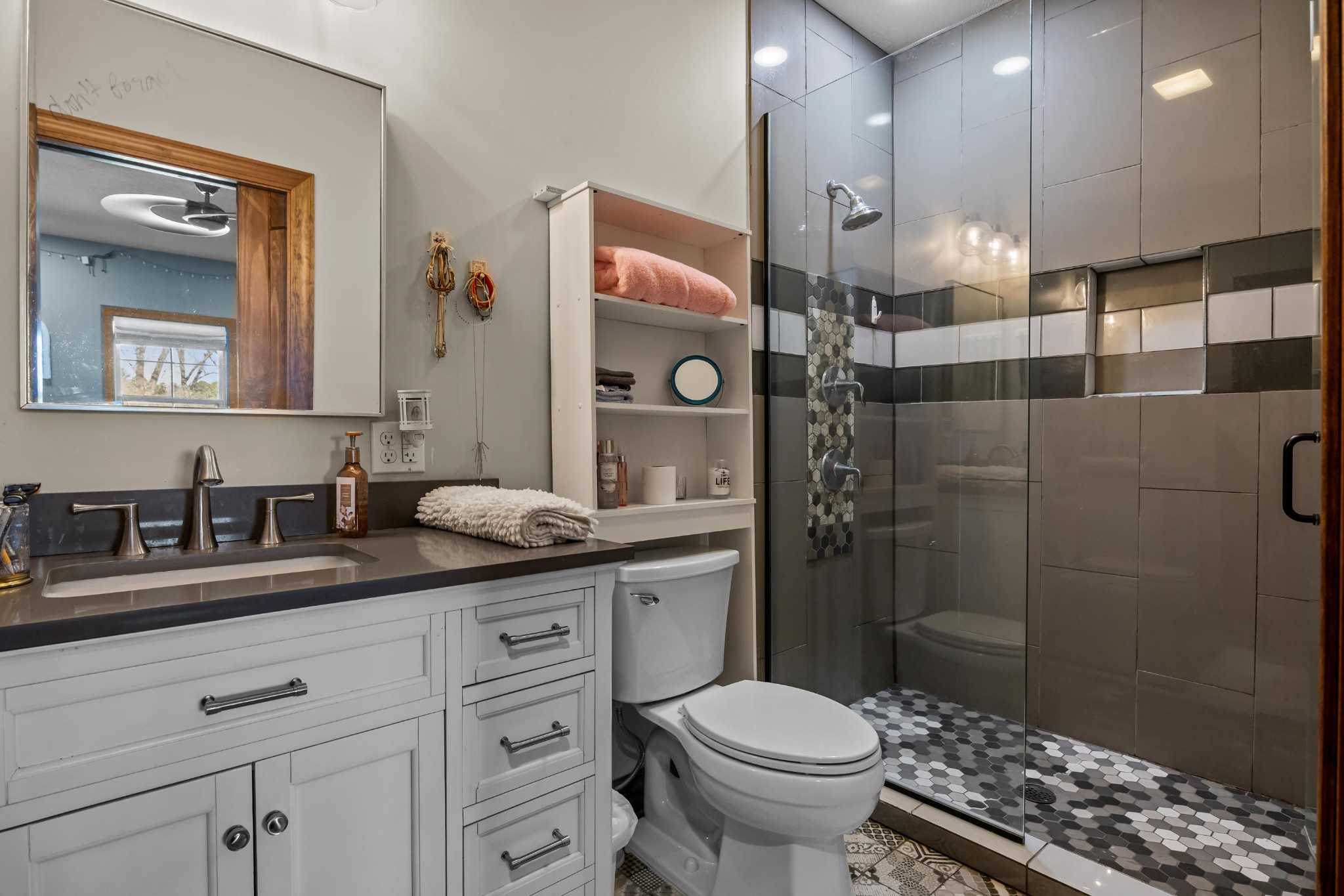 1816 McKelvy Road Camden, TN 38320 - Photo 38 of 100 a bathroom with a granite countertop sink a toilet a mirror and shower