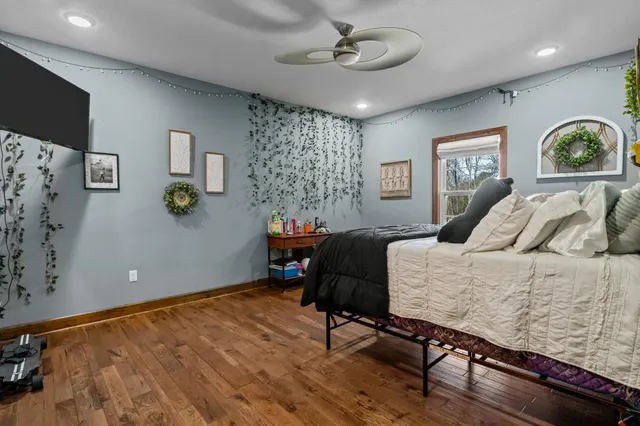 a front view of a house with a yard covered in snow