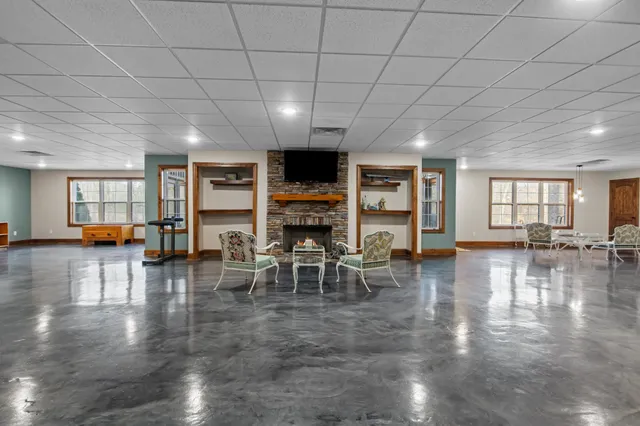 a living room with furniture a window and a fireplace
