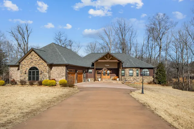 a living room with furniture a fireplace and a chandelier