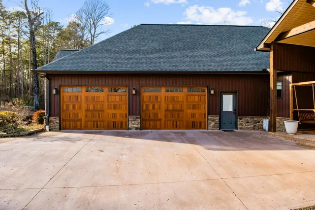 a living room with furniture a fireplace and a large window